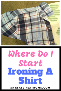 Blue plaid shirt and sleeve on the end of an ironing board
