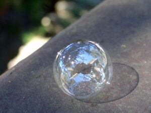 Shiny bubble sitting on concrete