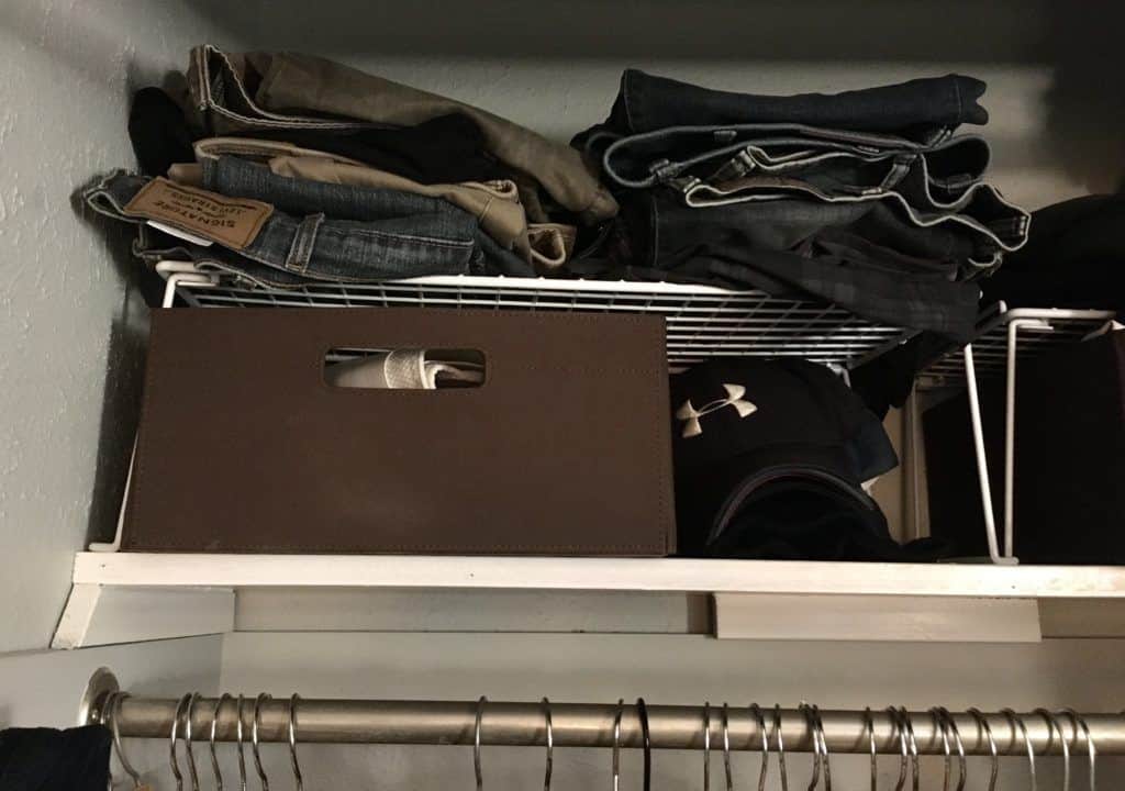 Brown fabric storage bin with white wire shelf on closet shelf