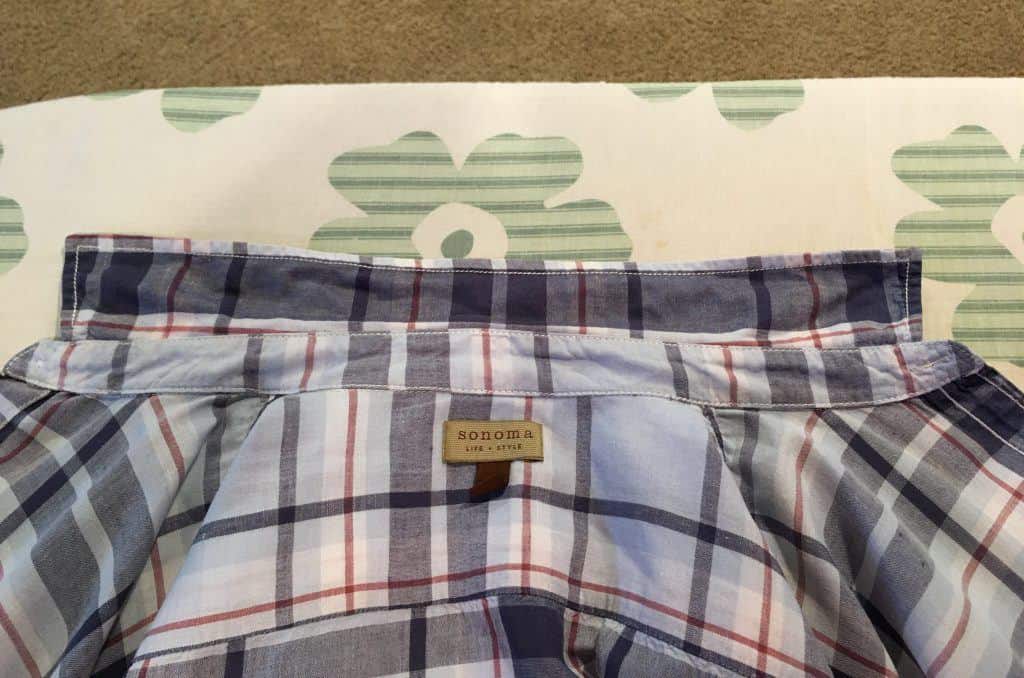Inside of blue plaid shirt and collar on an ironing board