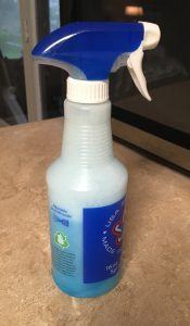 Spray bottle filled with Dawn detergent and vinegar on a counter top